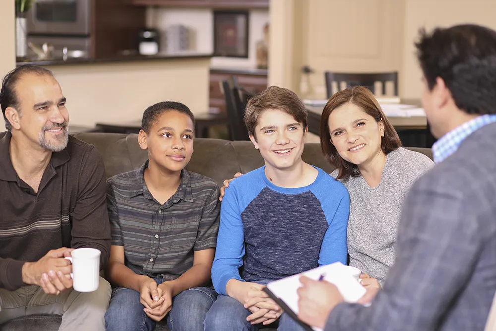mother and father with two boys at a therapist appointment